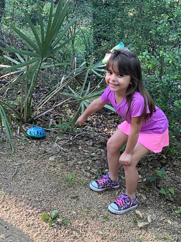 Little girl with painted rock